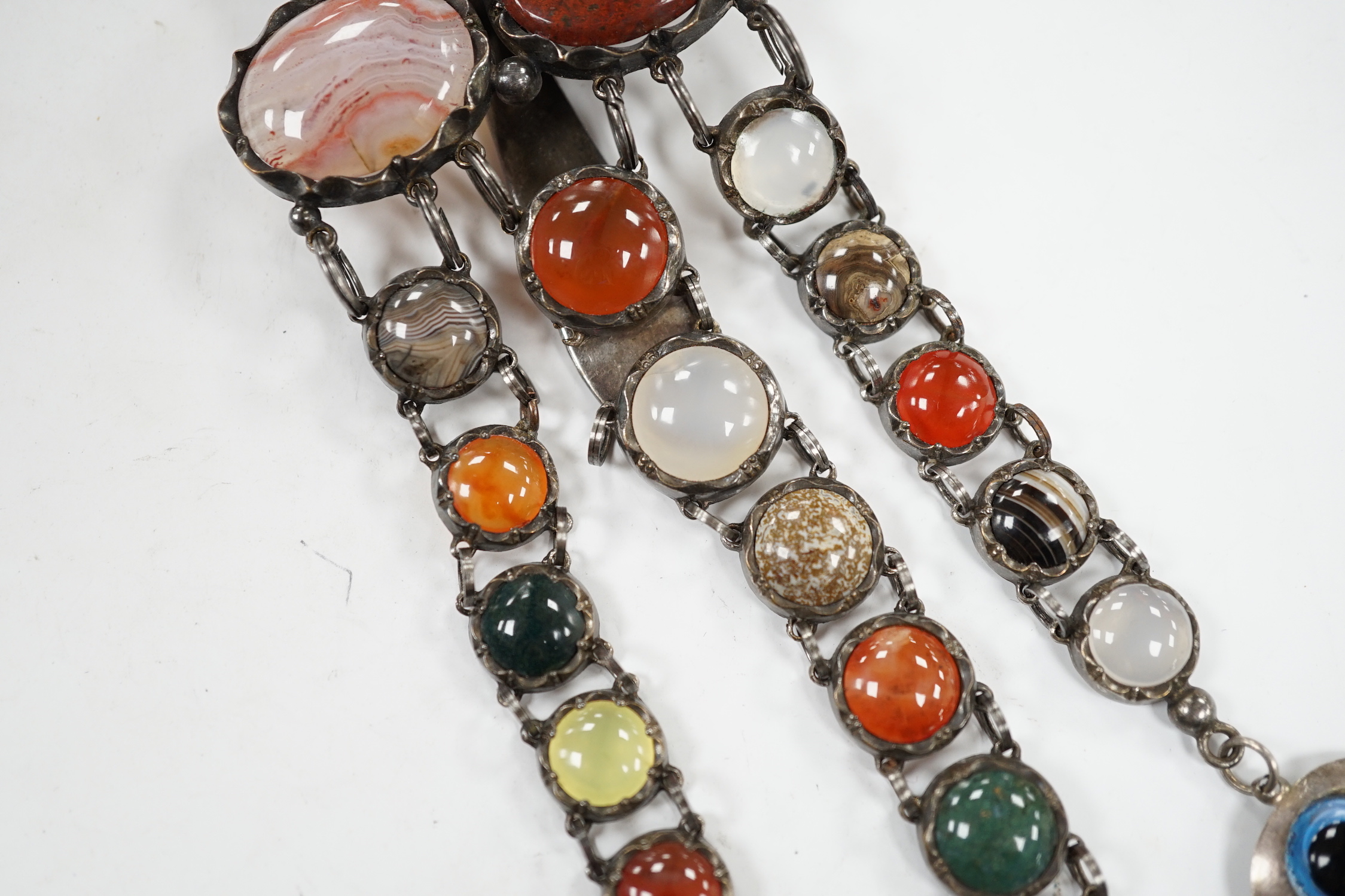 A white metal and cabochon multi gem set chatelaine, including jasper, carnelian and banded agate, 17cm.